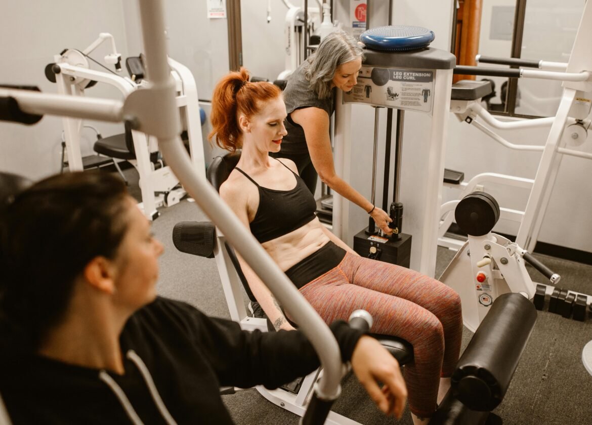 Women working out on gym equipment, promoting strength and fitness.