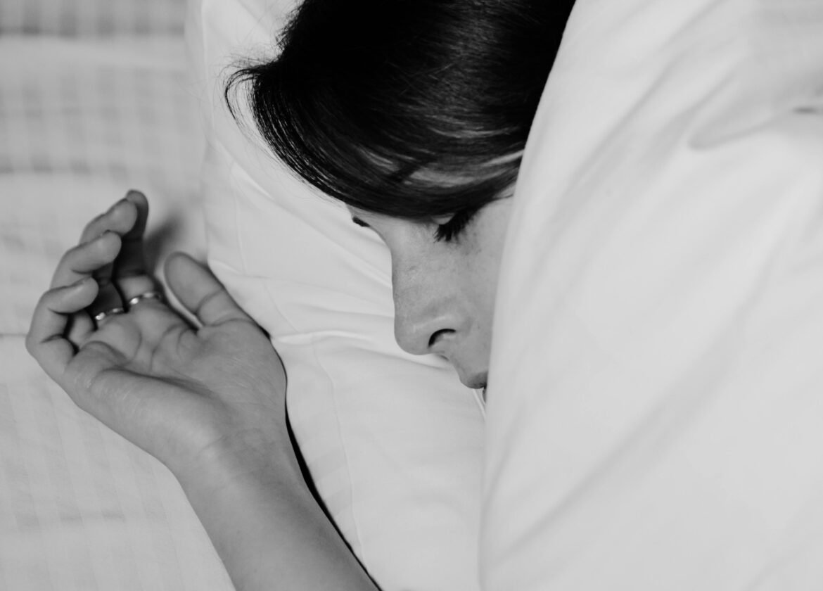 Close-up of a person sleeping peacefully, captured in monochrome for a serene feel.