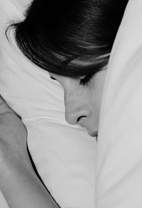 Close-up of a person sleeping peacefully, captured in monochrome for a serene feel.