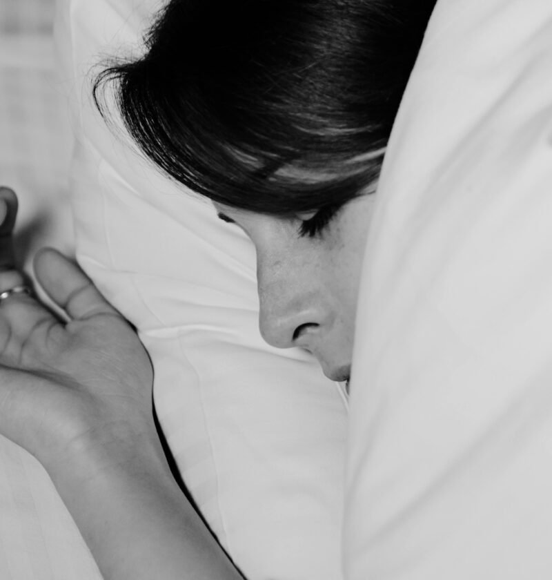Close-up of a person sleeping peacefully, captured in monochrome for a serene feel.