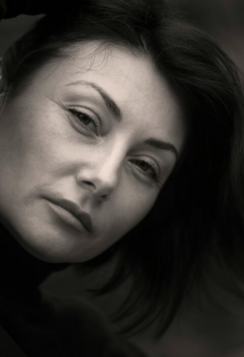 Monochrome portrait of an adult woman with a thoughtful expression.